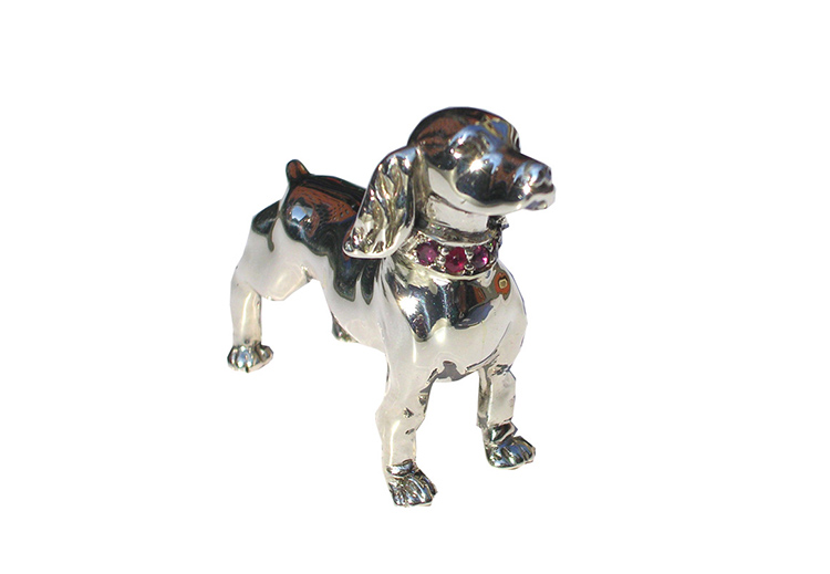 Lost wax carving of a dog cast in silver and set with ruby’s-Daniel Gallie